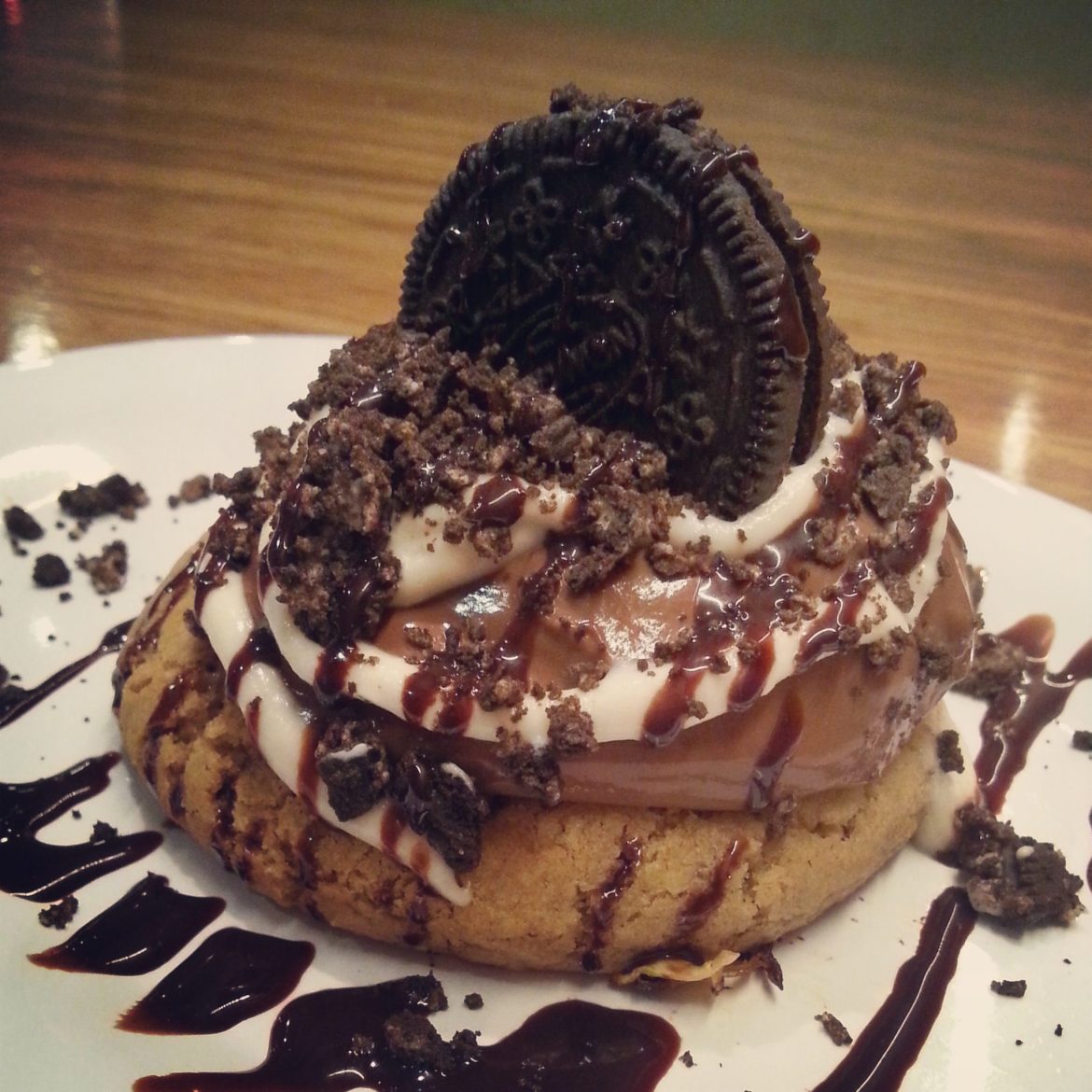 Vegan grilled chocolate chip cookie with chocolate pudding, creme fresh, cookie crumbles, chocolate syrup, and oreo on top (Veggie Grill)